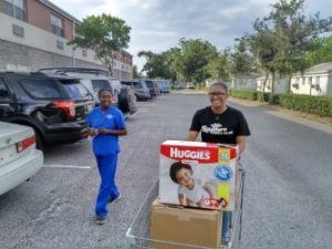 thumbnail_Lourdes Ernes(l) and Kienda Thomas(r)_donating old items.jpg.png